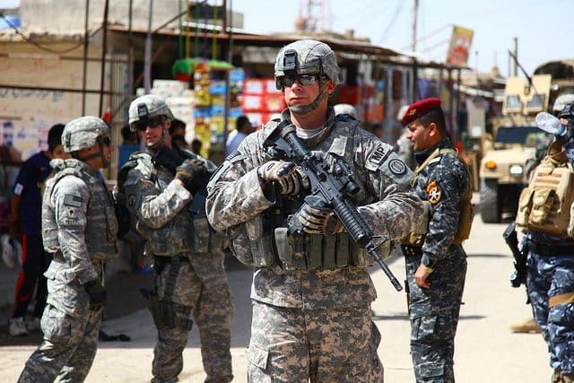 U.S. Army Sgt. 1st Class Thomas C. Shcur from the 203rd Military Police Battalion, 49th MP Brigade, during a joint community policing patrol in Basra, Iraq, April 3, 2010. Schur is a member of the Police Transition and Security Team, which is responsible for training the Iraqi police forces. (U.S. Army photo by Staff Sgt. Adelita Mead/RELEASED)