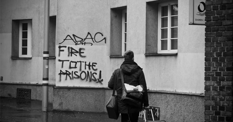 "Fire to the prisons!" graffiti