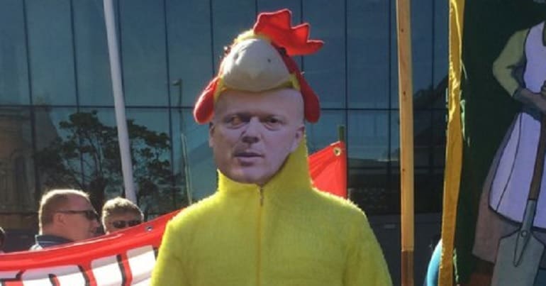 Protester in a Chris Grayling mask and a chicken suit during the Labour rail campaign day