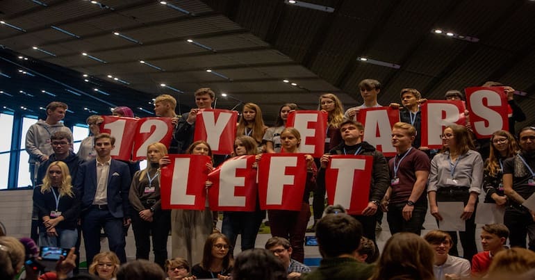 Students display a message saying there are only 12 years left to get off fossil fuels.