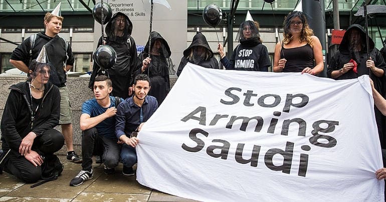 Protesters outside Department for Business with 'stop arming Saudi' banner