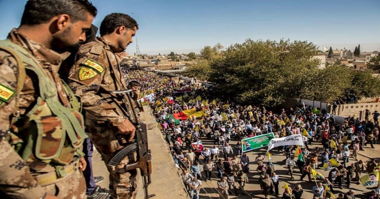 YPG fighters looking down at a demonstration in Rojava, January 2018.