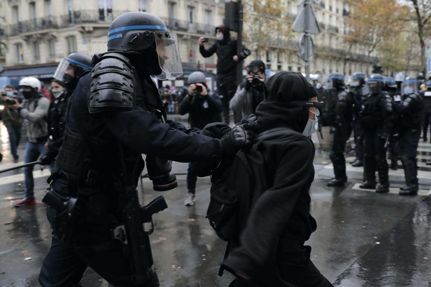 Riot police in Paris manhandling a protestor