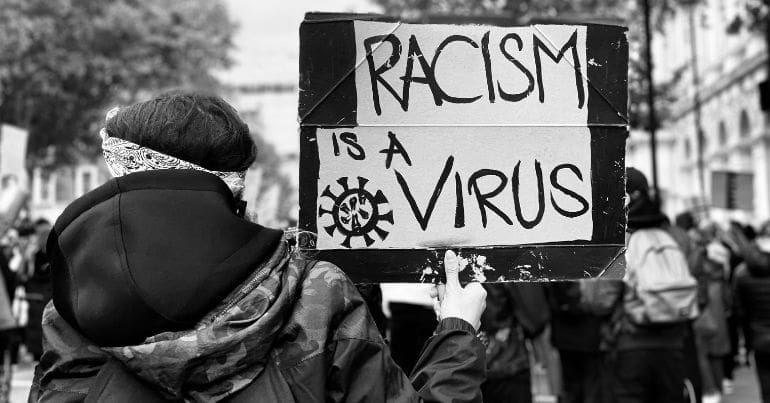 "Racism is a virus" BLM sign