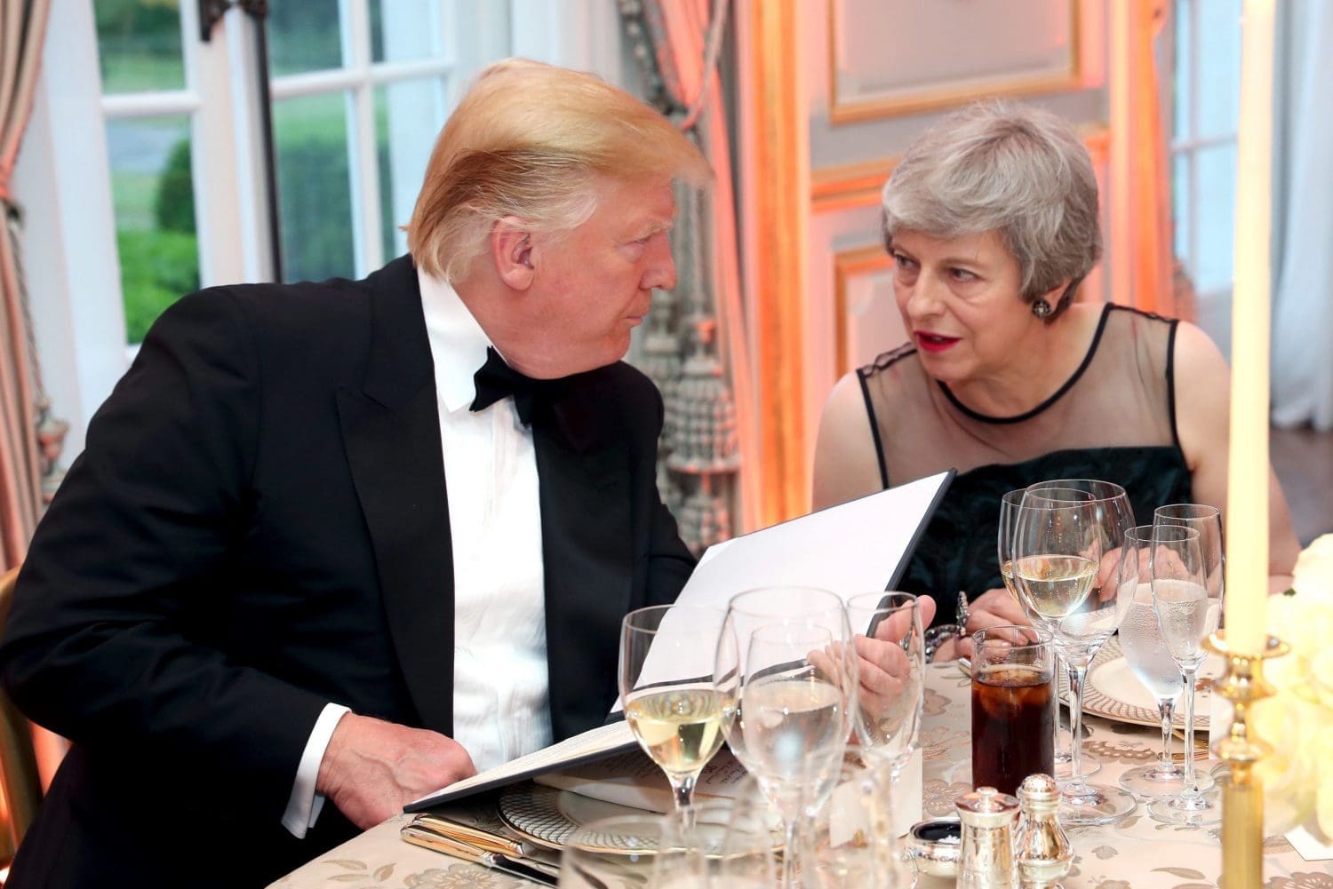 Donald Trump and Theresa May sitting at a black tie event