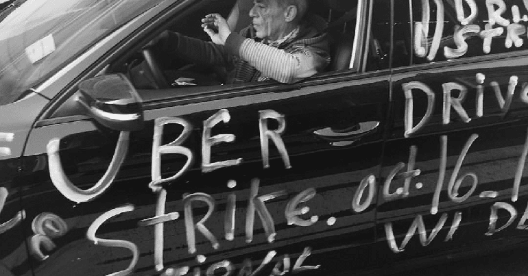 Taxi painted with the words "Uber Drivers Strike Oct 16"