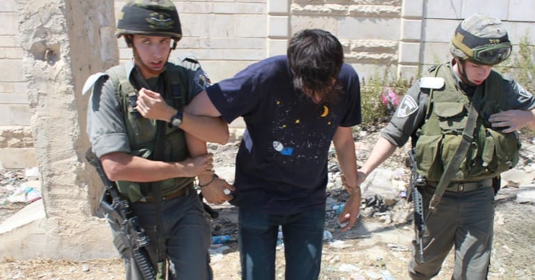 Israeli police arrest a Palestinian demonstrator in 2011