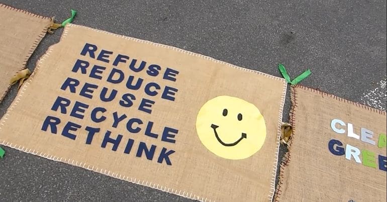 An embroided environmental poster saying refuse, reduce, reuse, recycle and rethink