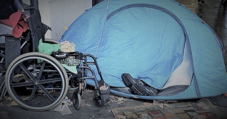 A disabled homeless persons tent and a wheelchair at the Peoples Assembly demo