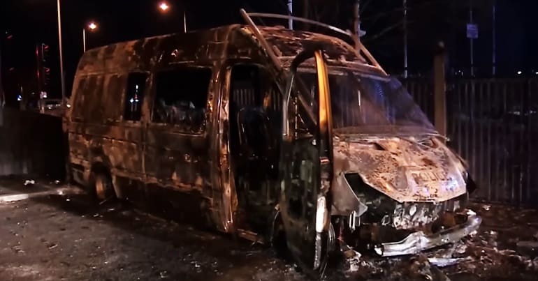 A burned out police van in Knowsley after a fascist attack against refugees