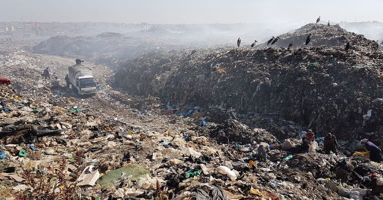 Wide shot showing Dandora landfill, which is the final resting place of tonnes of used clothing donations from Europe that go on to become plastic waste