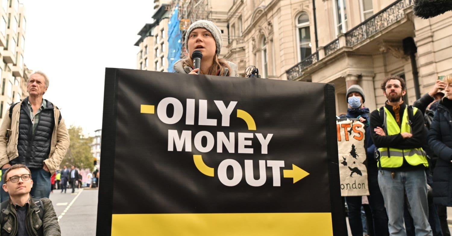 Climate activists including Fossil Free London disrupt the Energy Intelligence Forum, London, UK. Greta Thunberg holds a banner that reads: Oily money out.