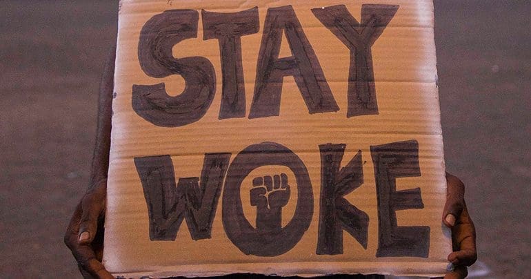 Handmade placard saying "STAY WOKE"