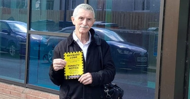 Welsh language campaigner holding a parking fine