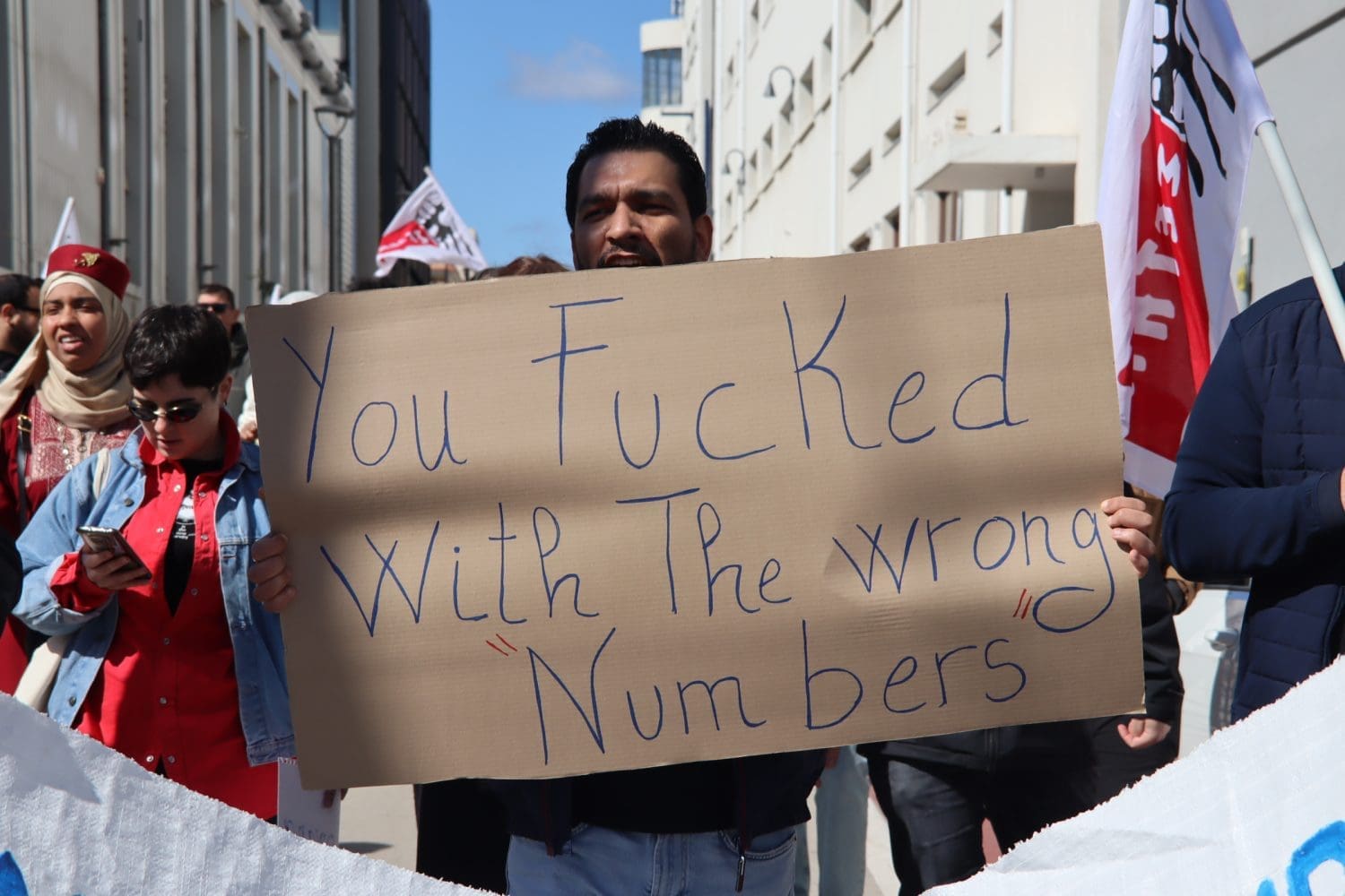 A placard that reads "you fucked with the wrong numbers"