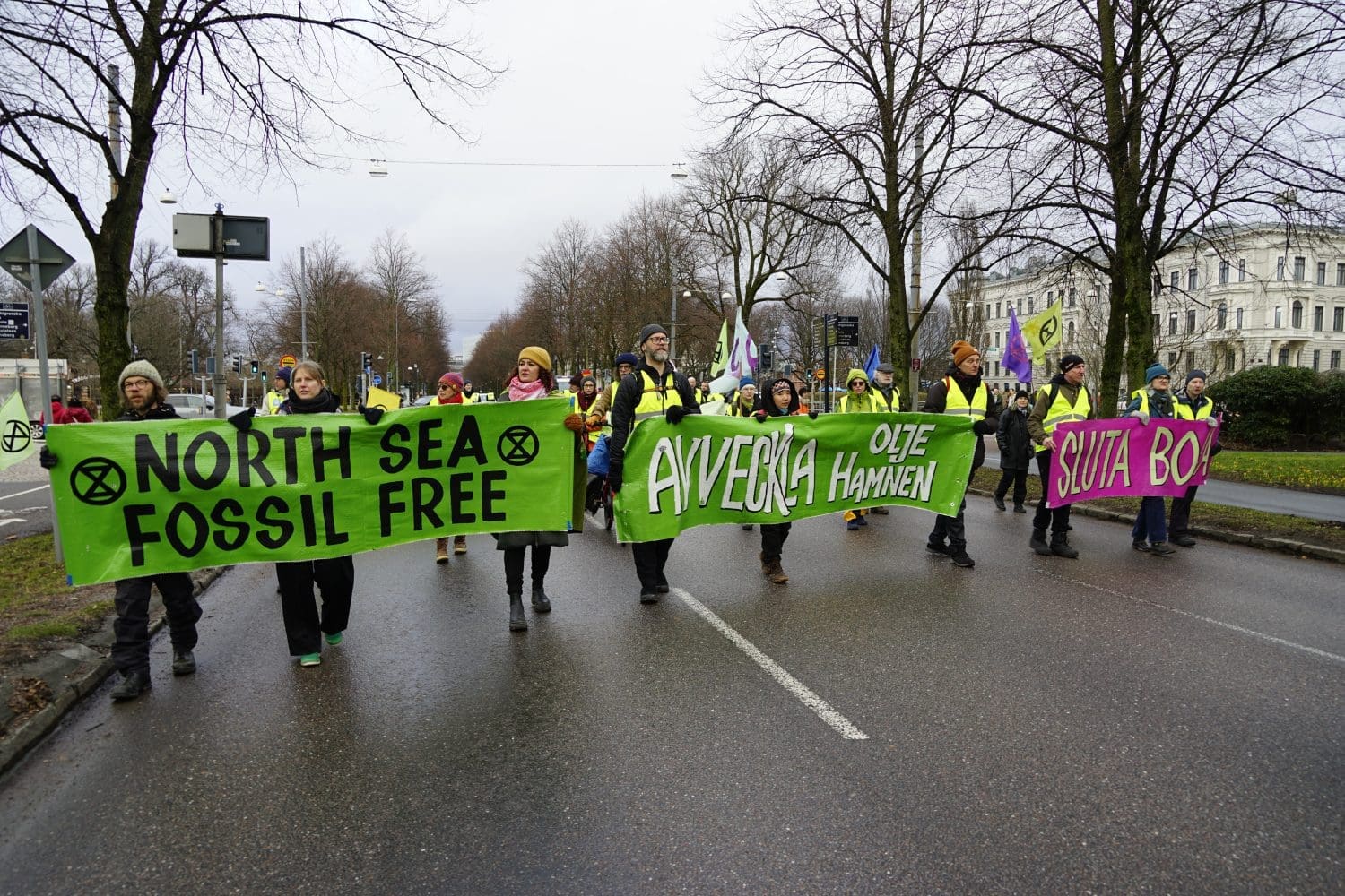 North Sea Extinction Rebellion activists walking with banner that reads 'north sea fossil free'