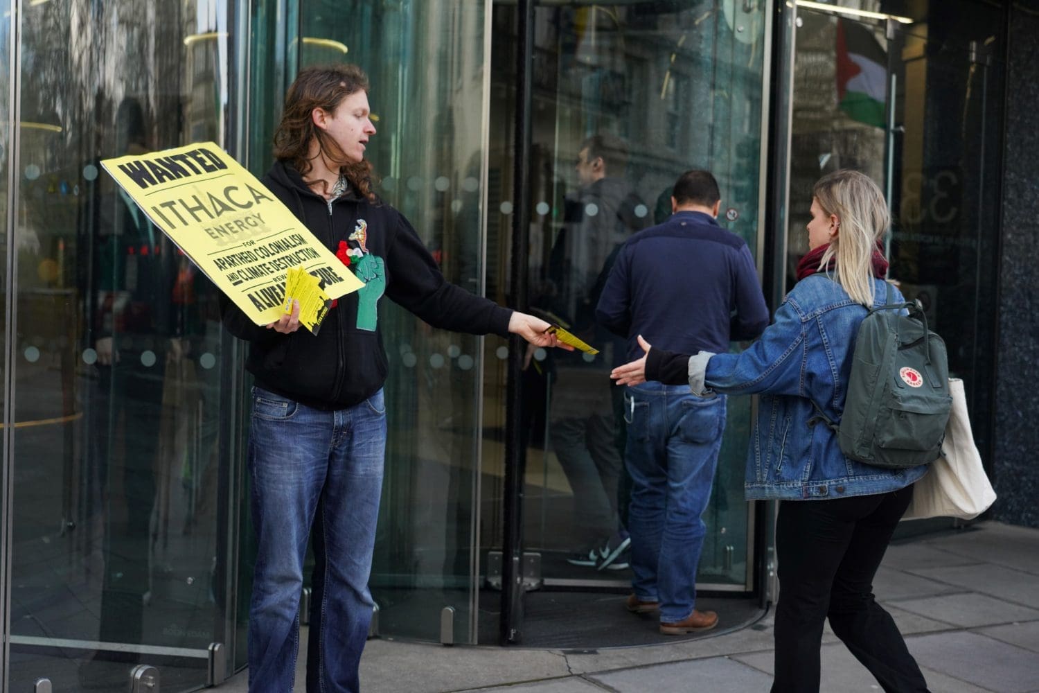 Activists hand information leaflets to Ithaca employees.