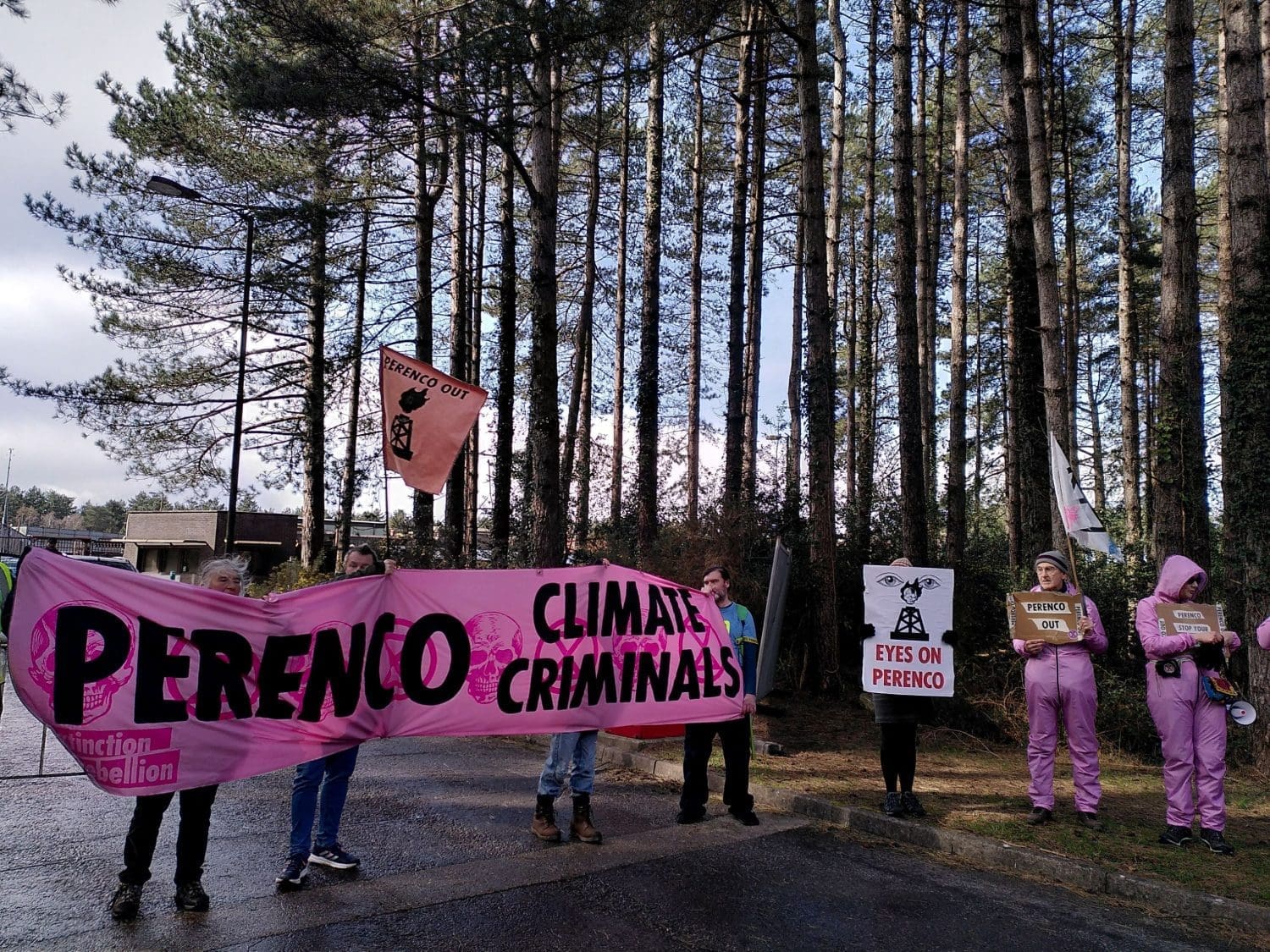 Activists block Wytch Farm's main entrance with placards and banners. One reads: "Perenco Climate Criminals" while another states: "Eyes on Perenco".