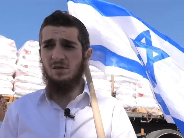 Israel settler holding the Israeli flag