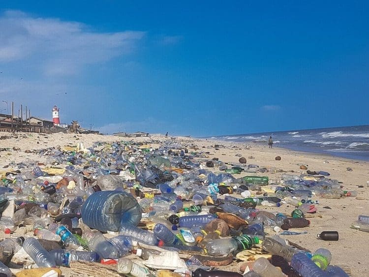 Image shows plastic pollution covering Accra beach, Ghana INC