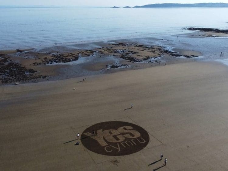 YesCymru logo on Wales beach Crown Estate