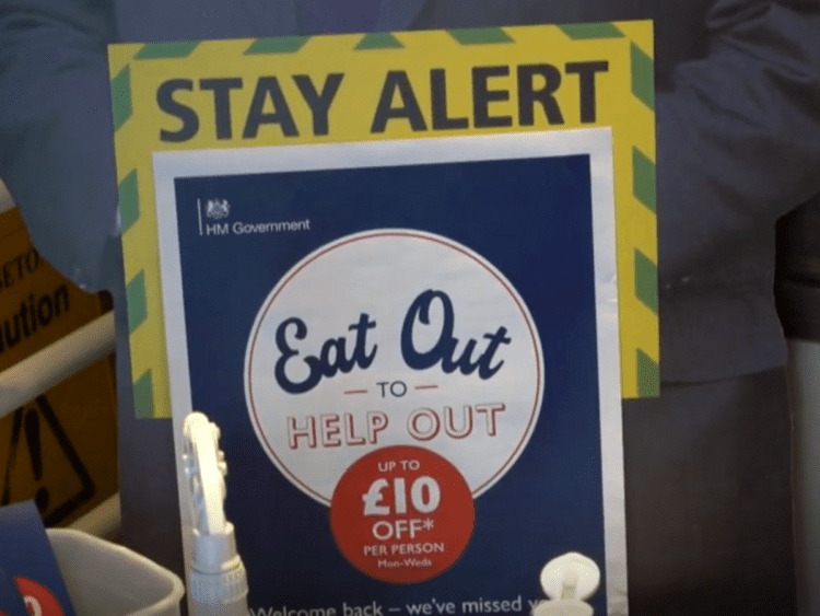 Eat out to help out poster, with a sign behind saying "stay alert".