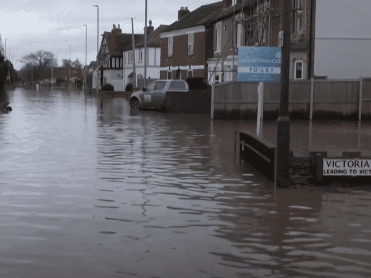 Flooding down a UK residential street climate insurance weather