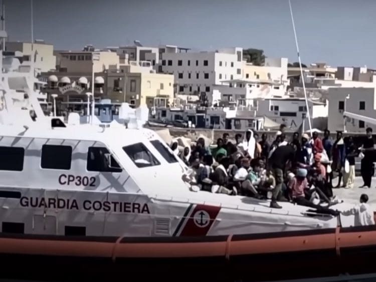 Coastguard ship in a port with refugees EU migration pact