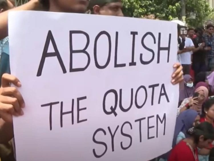 Bangladesh protesters hold a placard that reads: "Abolish the quota system"